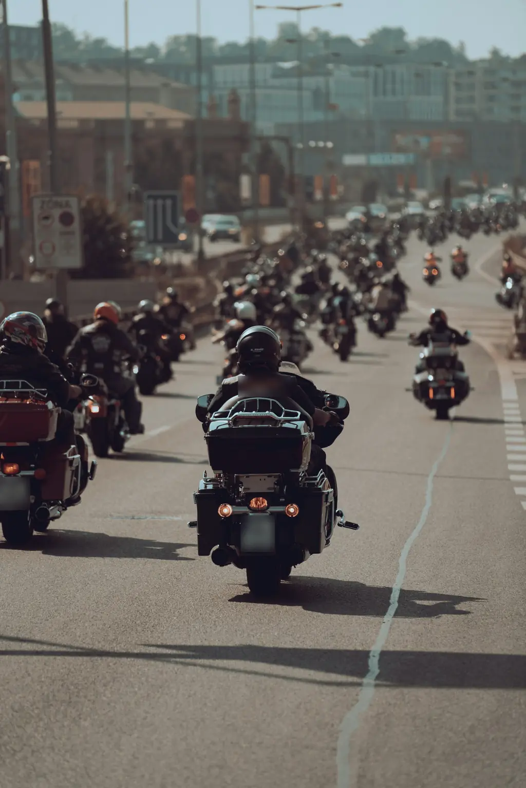 Riders on cruisers heading down a city street