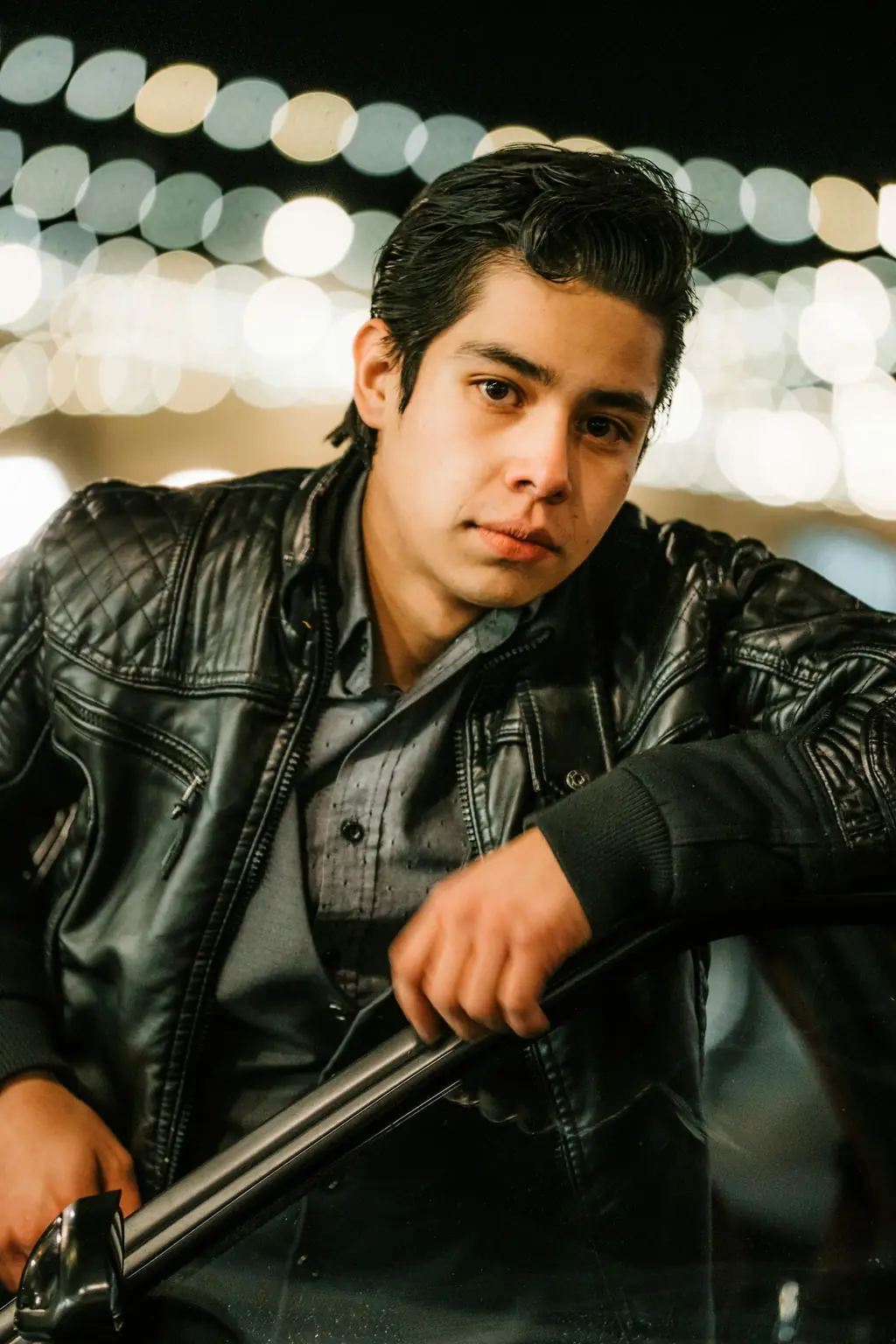 A young rider in a black leather jacket