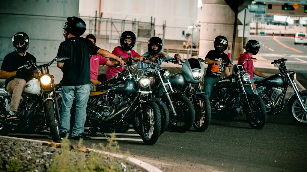 A rider standing beside his black cruiser