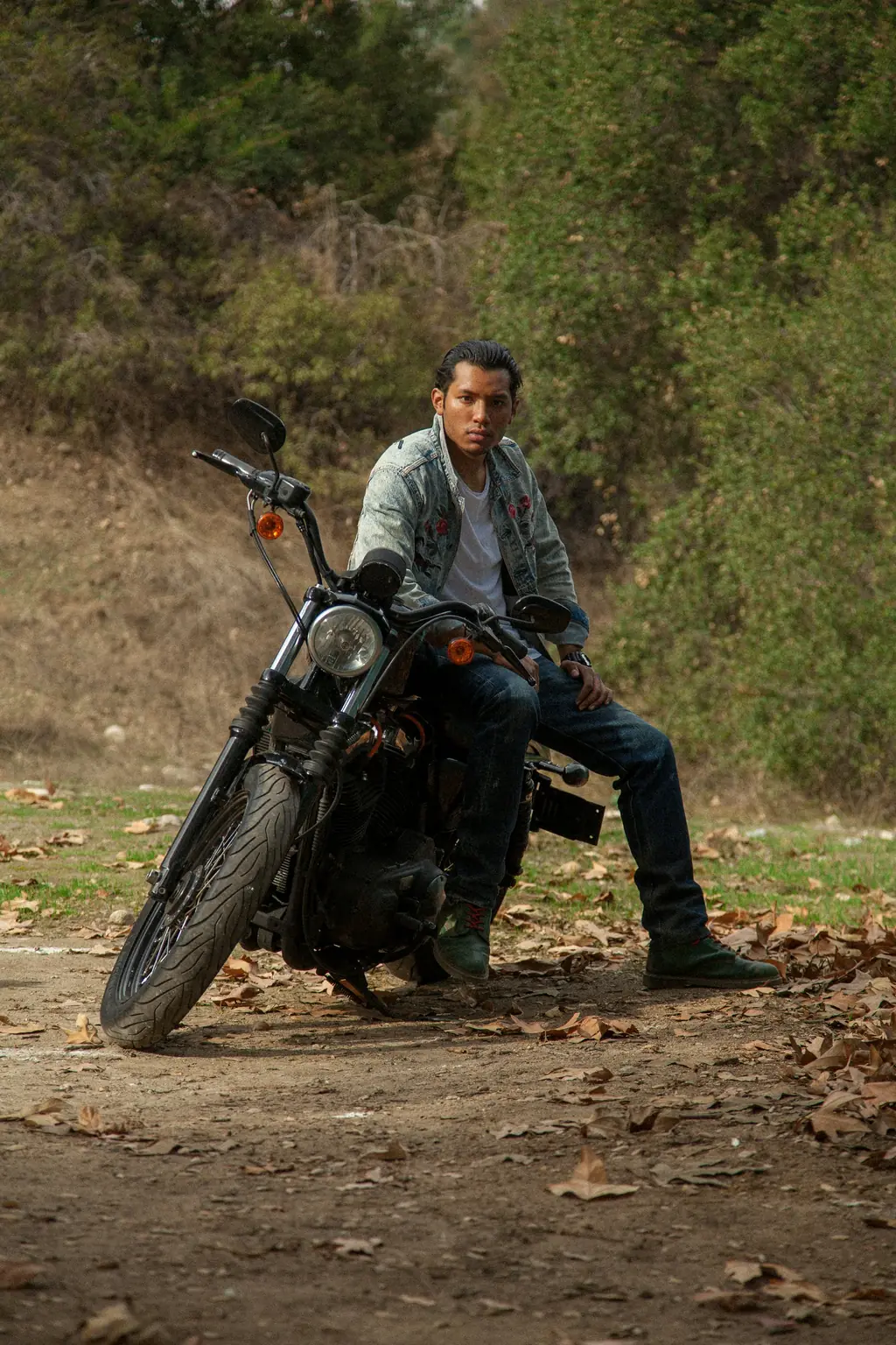 A rider leaning on his motorcycle